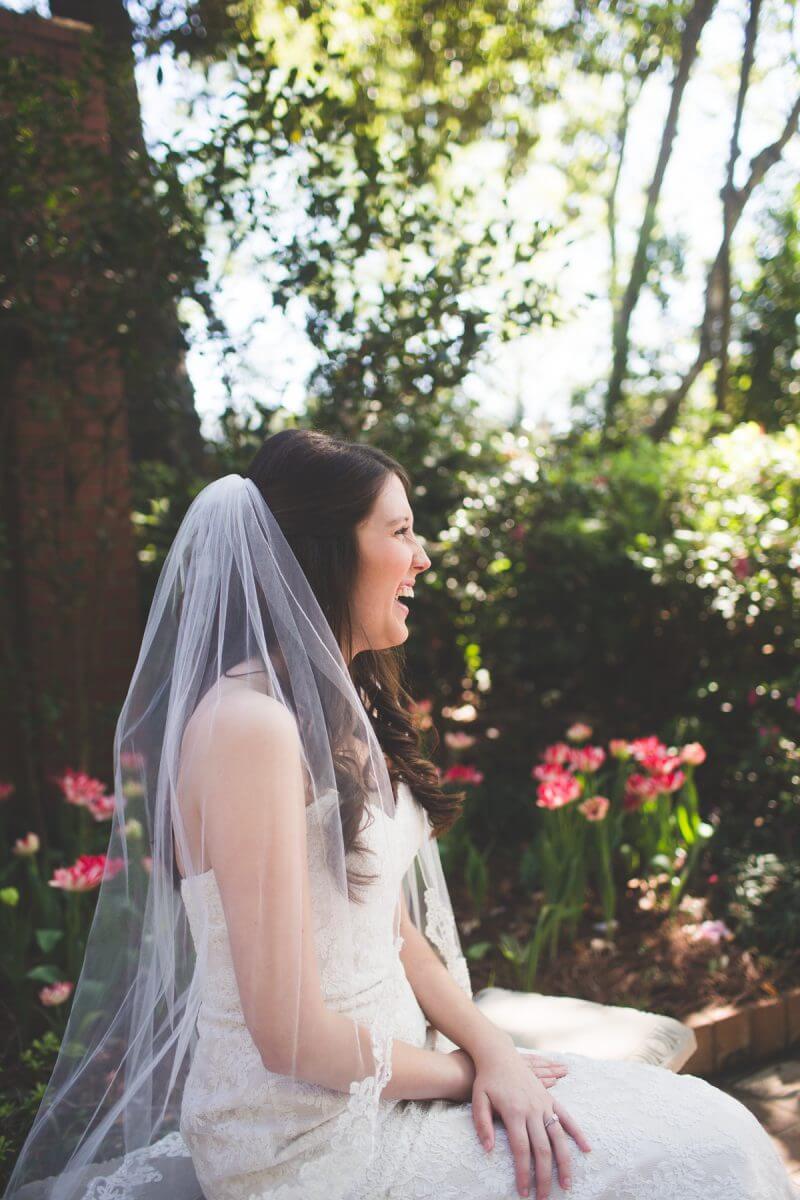 Bride laughing on bench during bridal session