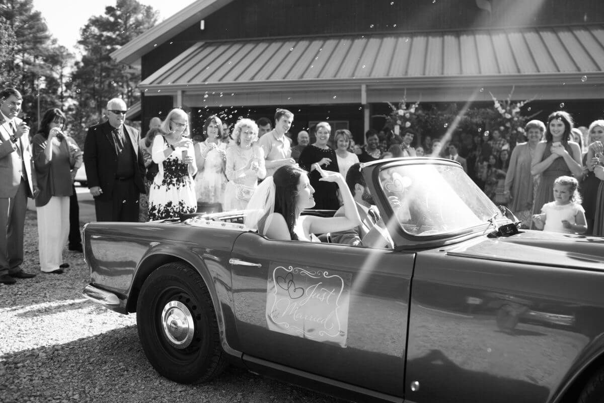 couple leaving ruston, louisiana wedding in vintage car