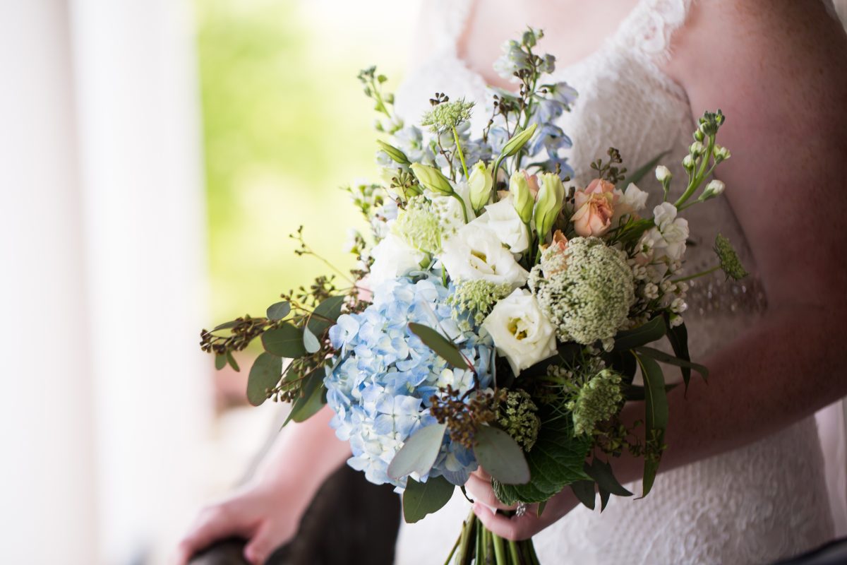 close up of bouquet with hydrangea and white roses