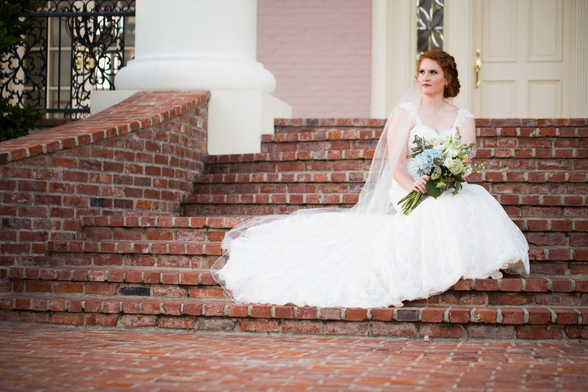 bride sitting on front steps at Mansion at Red Hill