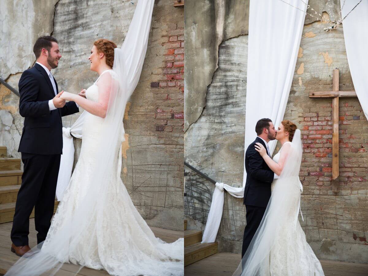 bride and groom laughing and kissing in front of brick wall at Norton Building in Ruston, LA