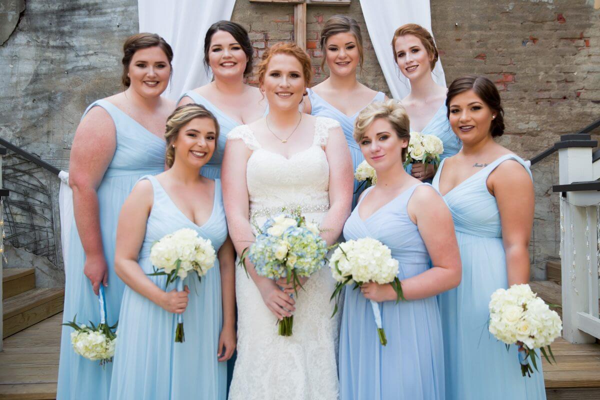 beautiful bride and brides maids standing on raised dais at the Norton Building in Ruston, LA