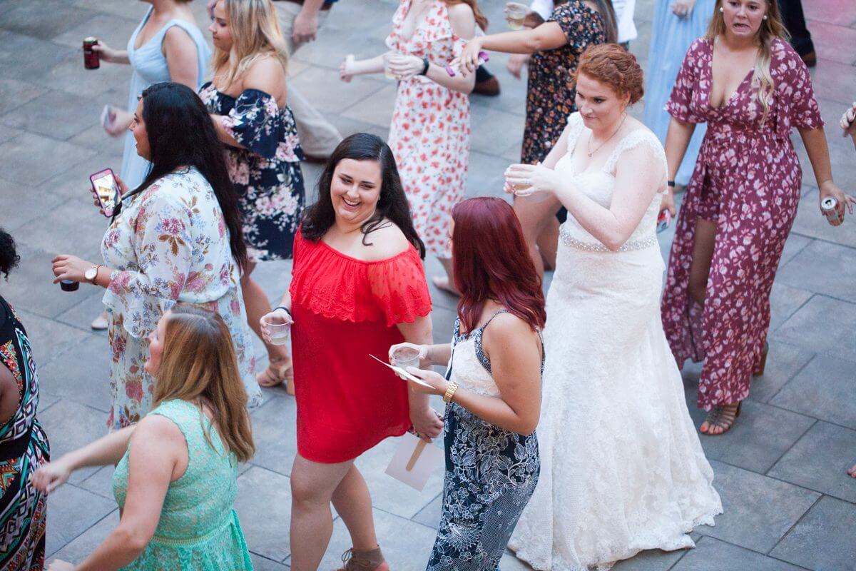 bride and guests dancing at wedding reception in courtyard of Norton Building in Ruston, LA