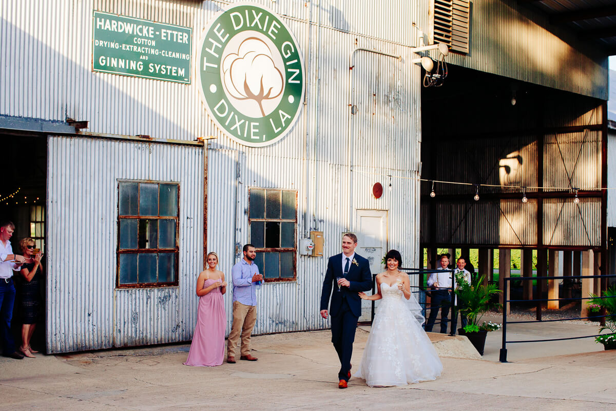 bride and groom entering their wedding reception at the Dixie Gin in Shreveport, Louisiana