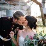marine groom kissing bride in wedding dress at The Dixie Gin in Shreveport, Louisiana